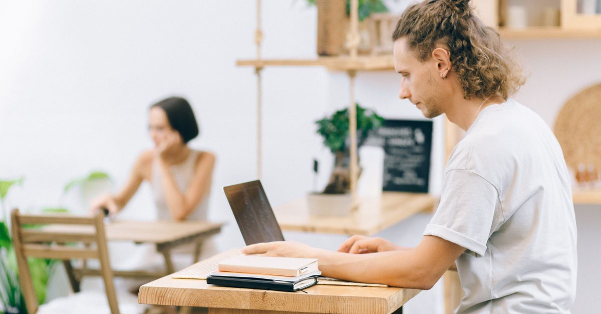 Remote workers on laptops in a bright modern coworking space in Bali