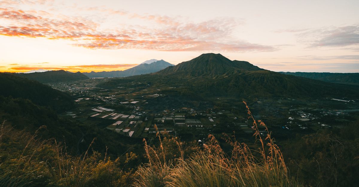 Sunrise over Mount Batur volcano and crater lake in Kintamani, Bali